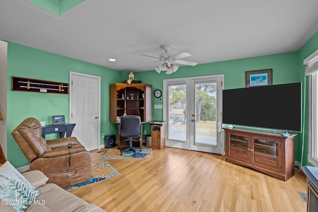 home office with french doors, light hardwood / wood-style flooring, and ceiling fan