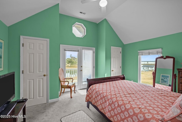 bedroom featuring ceiling fan, light colored carpet, access to outside, and multiple windows