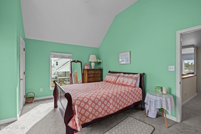 bedroom with light colored carpet and vaulted ceiling