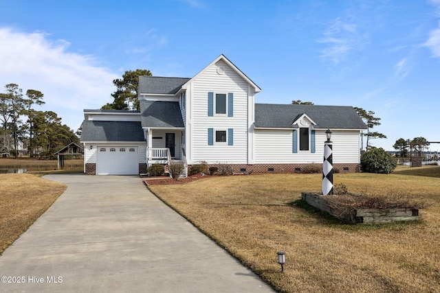 front of property featuring a front lawn, covered porch, and a garage