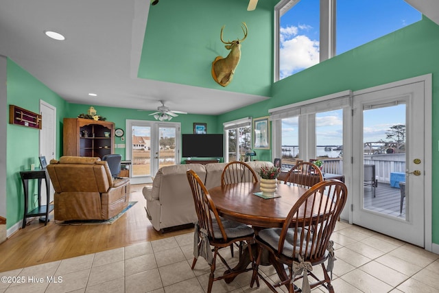 tiled dining room with french doors and ceiling fan