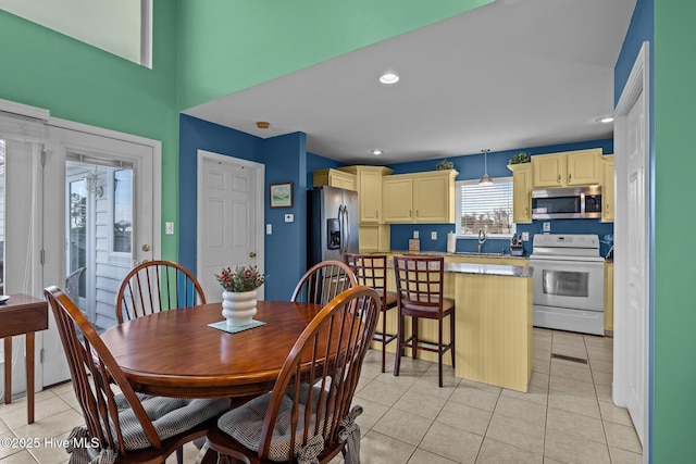 tiled dining room with sink