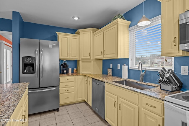 kitchen featuring pendant lighting, sink, light tile patterned floors, light stone counters, and stainless steel appliances