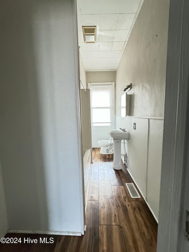 hall with dark hardwood / wood-style flooring and sink