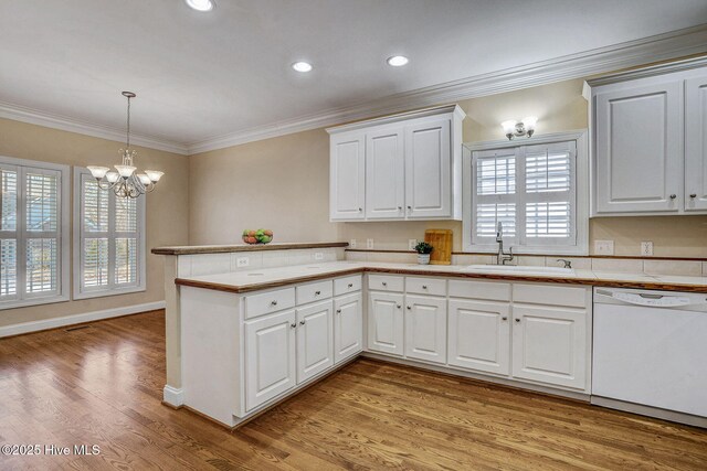 kitchen with light hardwood / wood-style flooring, tile countertops, white appliances, white cabinets, and ornamental molding