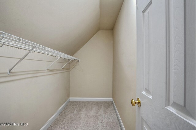 bathroom with tile patterned floors, vanity, toilet, and a skylight