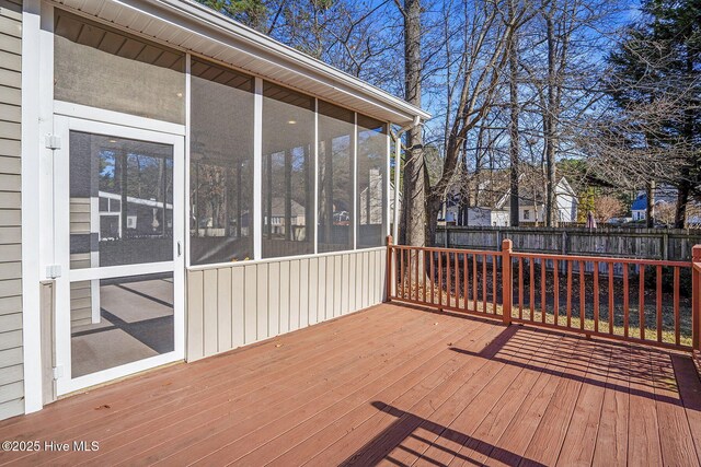 unfurnished sunroom featuring ceiling fan and wooden ceiling