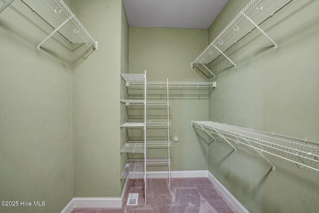 bathroom with tile patterned flooring, vanity, crown molding, and plus walk in shower