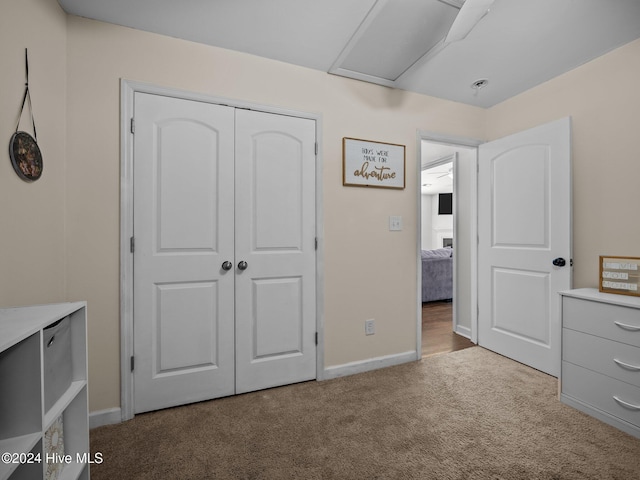 unfurnished bedroom featuring light carpet and a closet