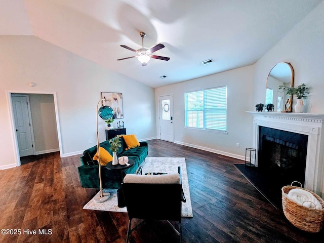 living room featuring vaulted ceiling, ceiling fan, and dark wood-type flooring