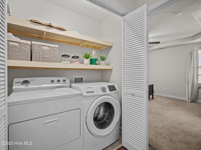 laundry room featuring ceiling fan, light colored carpet, and washing machine and clothes dryer