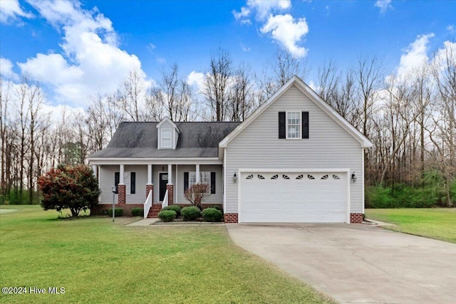 view of front of property with covered porch, a garage, and a front yard