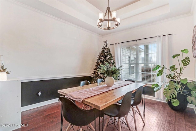 dining room featuring a chandelier, a tray ceiling, dark hardwood / wood-style floors, and crown molding