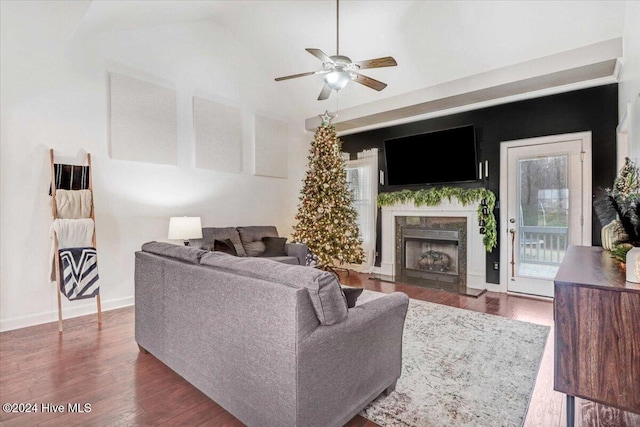 living room with ceiling fan and dark hardwood / wood-style flooring