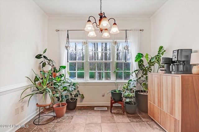 dining space featuring crown molding and a notable chandelier