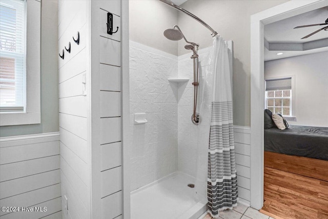 bathroom with ceiling fan, tile patterned flooring, and a shower with shower curtain