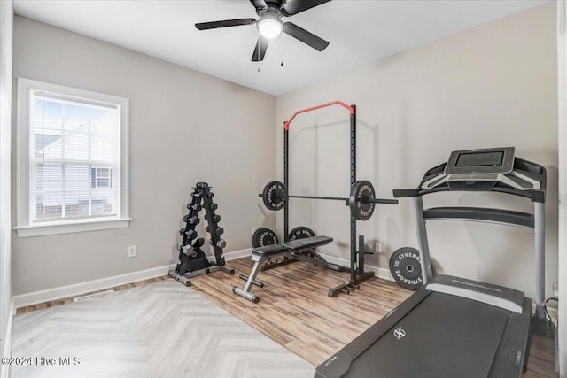 workout area featuring parquet floors and ceiling fan