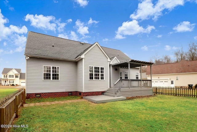 rear view of house with a lawn and a deck