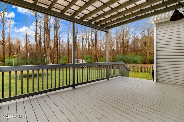 wooden deck featuring a yard and a trampoline