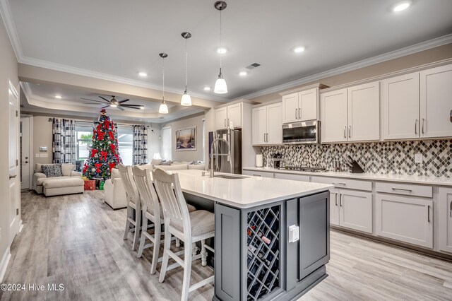 2023 Singing Palm Loop, Little River, SC 29566 - kitchen featuring a kitchen island with sink, a kitchen breakfast bar, hanging light fixtures, ceiling fan, and stainless steel appliances