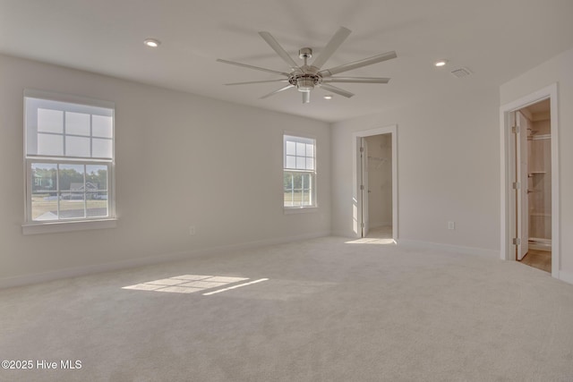 unfurnished room featuring light carpet and ceiling fan