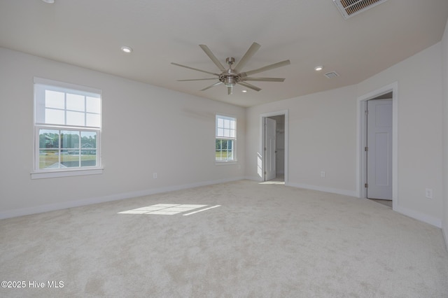 empty room featuring ceiling fan and light carpet