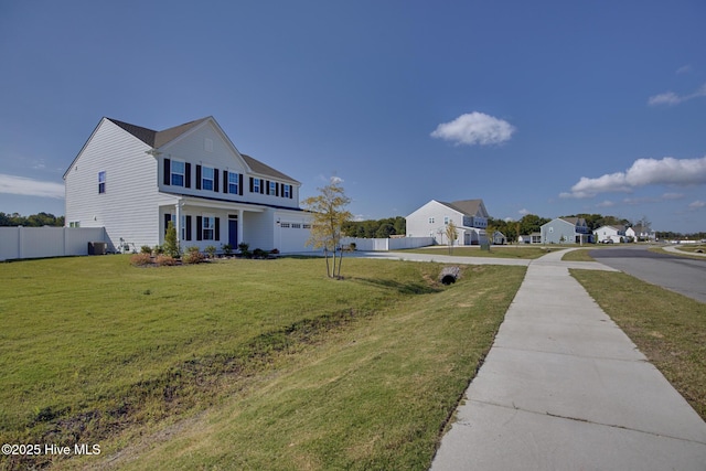 view of yard featuring a porch and a garage