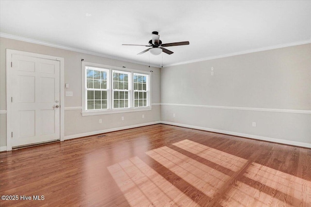 empty room featuring hardwood / wood-style floors, ceiling fan, and crown molding