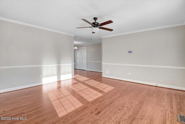 spare room featuring crown molding, light hardwood / wood-style flooring, and ceiling fan with notable chandelier