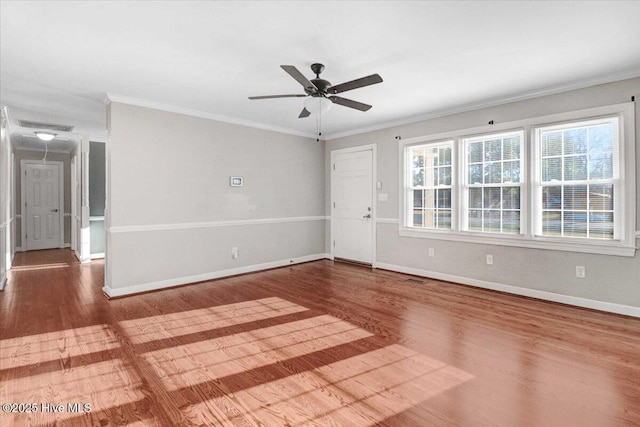 spare room with hardwood / wood-style flooring, ceiling fan, and crown molding