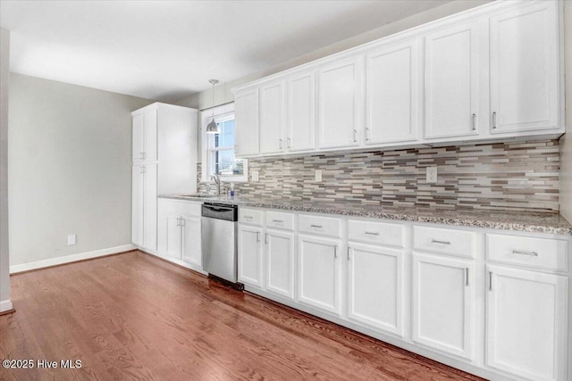 kitchen featuring dishwasher, white cabinets, sink, decorative backsplash, and light hardwood / wood-style floors