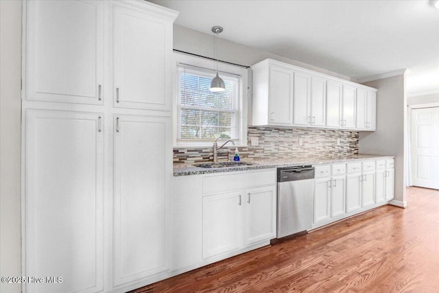 kitchen featuring white cabinetry, stainless steel dishwasher, and sink