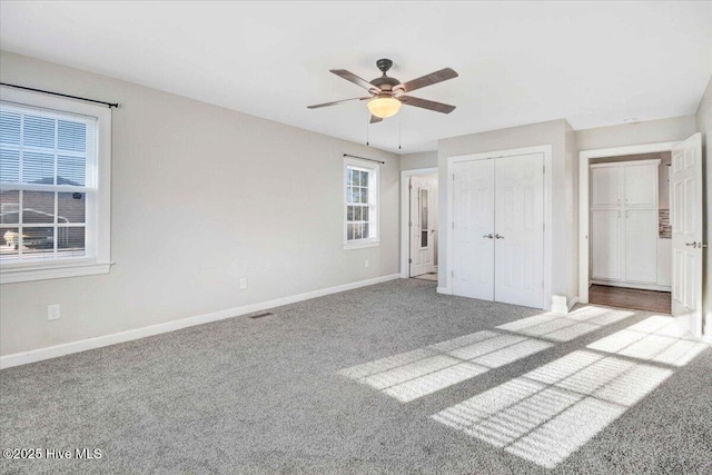 unfurnished bedroom featuring ceiling fan and light colored carpet