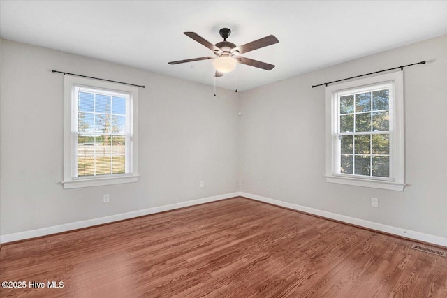 spare room featuring ceiling fan and hardwood / wood-style floors