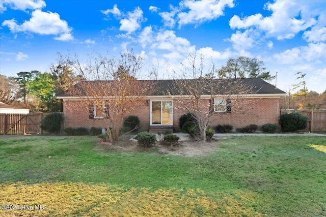 rear view of property featuring a yard