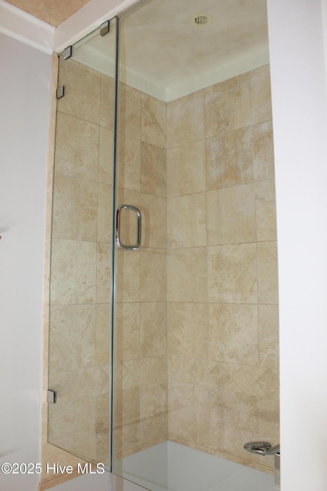 bathroom with a shower with door