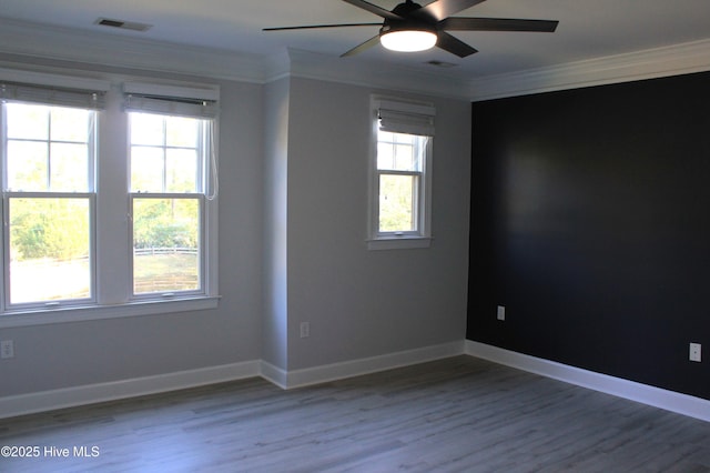 empty room featuring ceiling fan, wood-type flooring, and ornamental molding