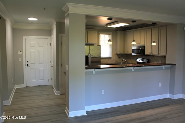 kitchen featuring kitchen peninsula, backsplash, stainless steel appliances, and ornamental molding