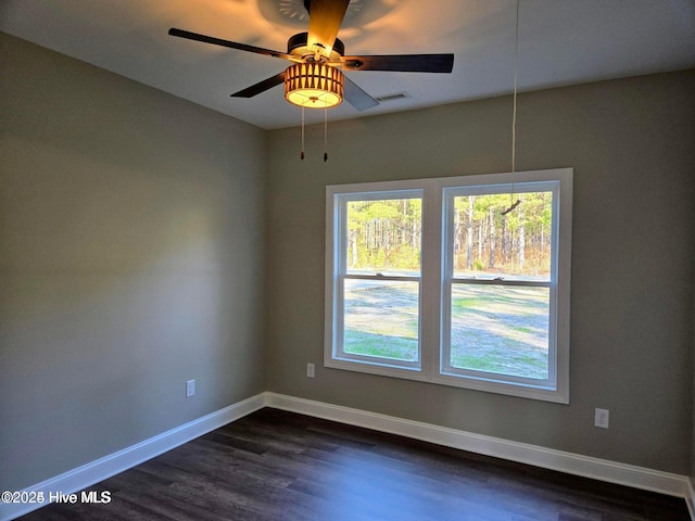 unfurnished room featuring dark hardwood / wood-style floors and ceiling fan