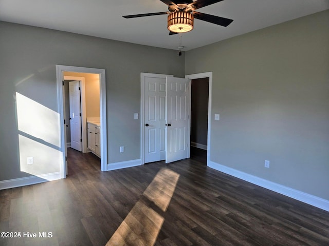 2587 Grifton Hugo Rd, Hookerton, NC 28538 - unfurnished bedroom featuring dark wood-style floors, baseboards, ensuite bathroom, and ceiling fan