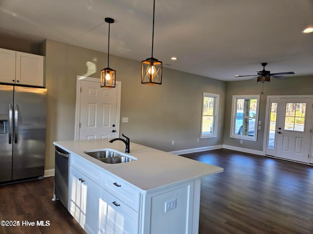 kitchen with white cabinets, sink, a center island with sink, and stainless steel appliances