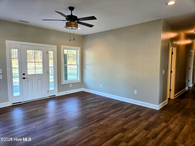 entrance foyer with ceiling fan and dark wood-type flooring