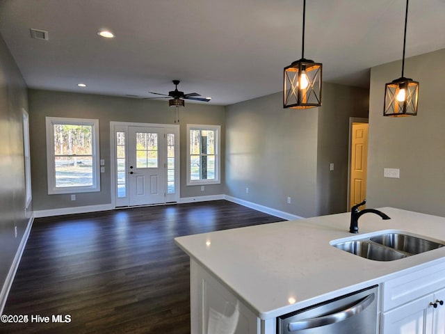 kitchen with ceiling fan, dishwasher, sink, pendant lighting, and white cabinets