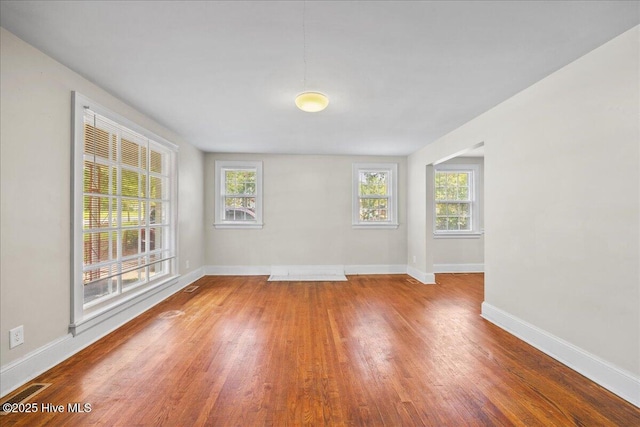 unfurnished room with wood-type flooring