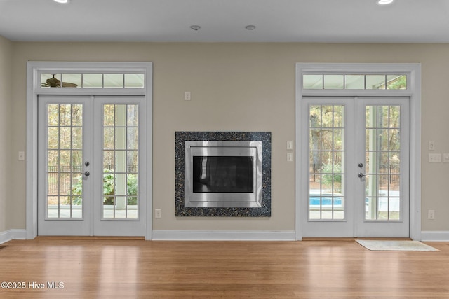 doorway to outside featuring french doors and light hardwood / wood-style flooring