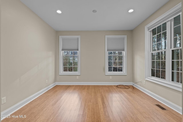 empty room with light hardwood / wood-style flooring