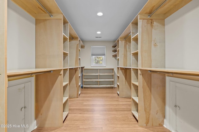 spacious closet featuring light hardwood / wood-style floors