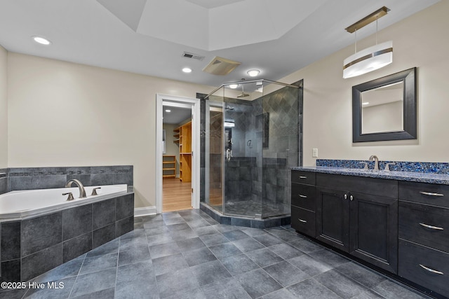 bathroom featuring vanity and independent shower and bath