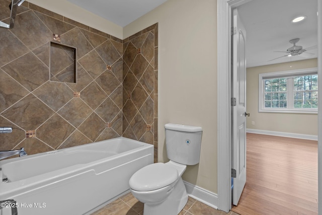 bathroom with tile patterned floors, tiled shower / bath combo, ceiling fan, and toilet