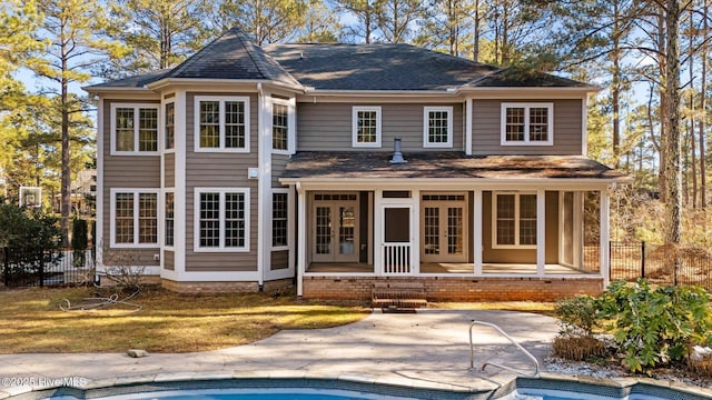 back of house with a fenced in pool, a patio area, french doors, and a yard